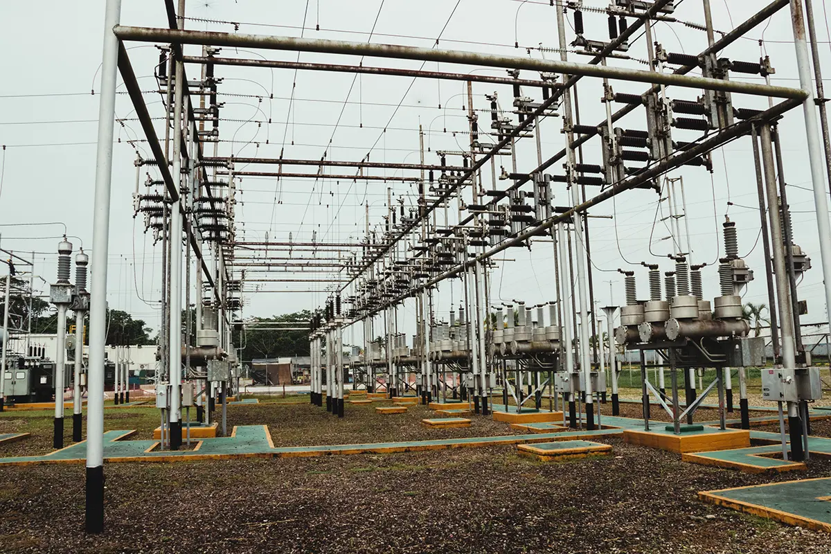 High-voltage electrical switchyard substation featuring fabricated steel gantry structures, portal frames, and overhead busbar supports