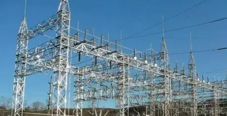 Detailed white steel lattice gantry structure and insulators inside an electrical power switchyard substation